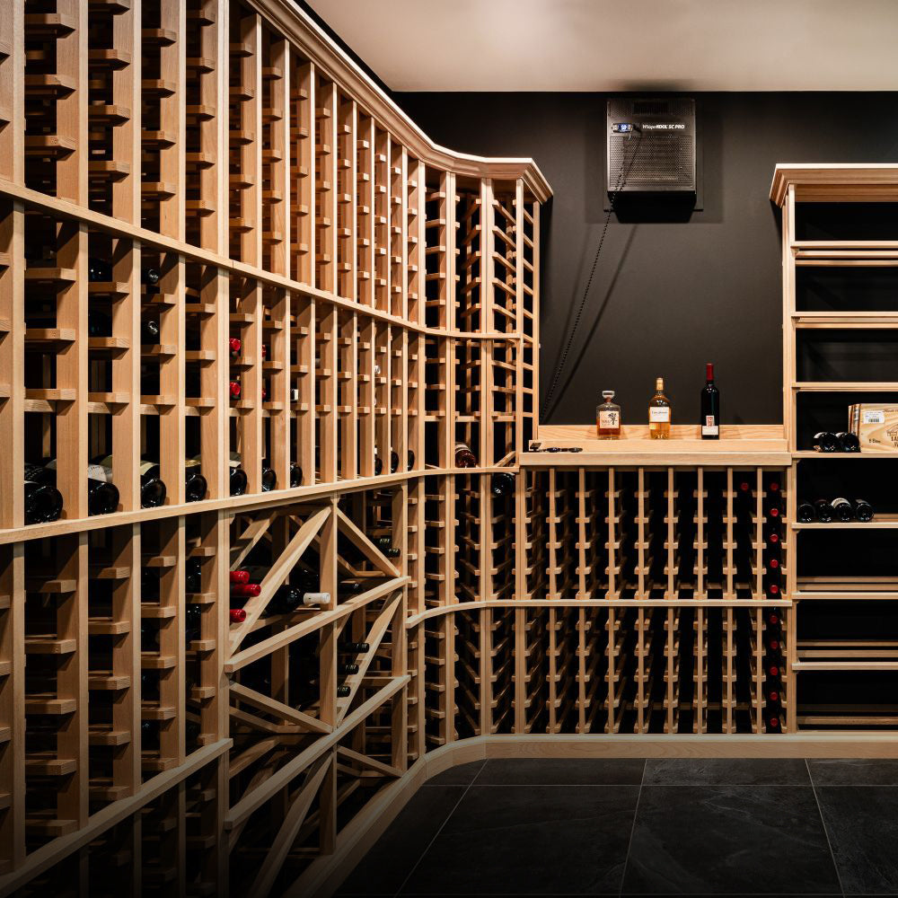 Wine cellar with wooden racks and bottles on a dark floor.