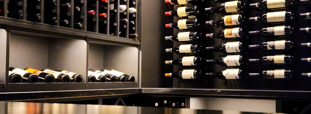 Wine bottles arranged on shelves in a wine cellar