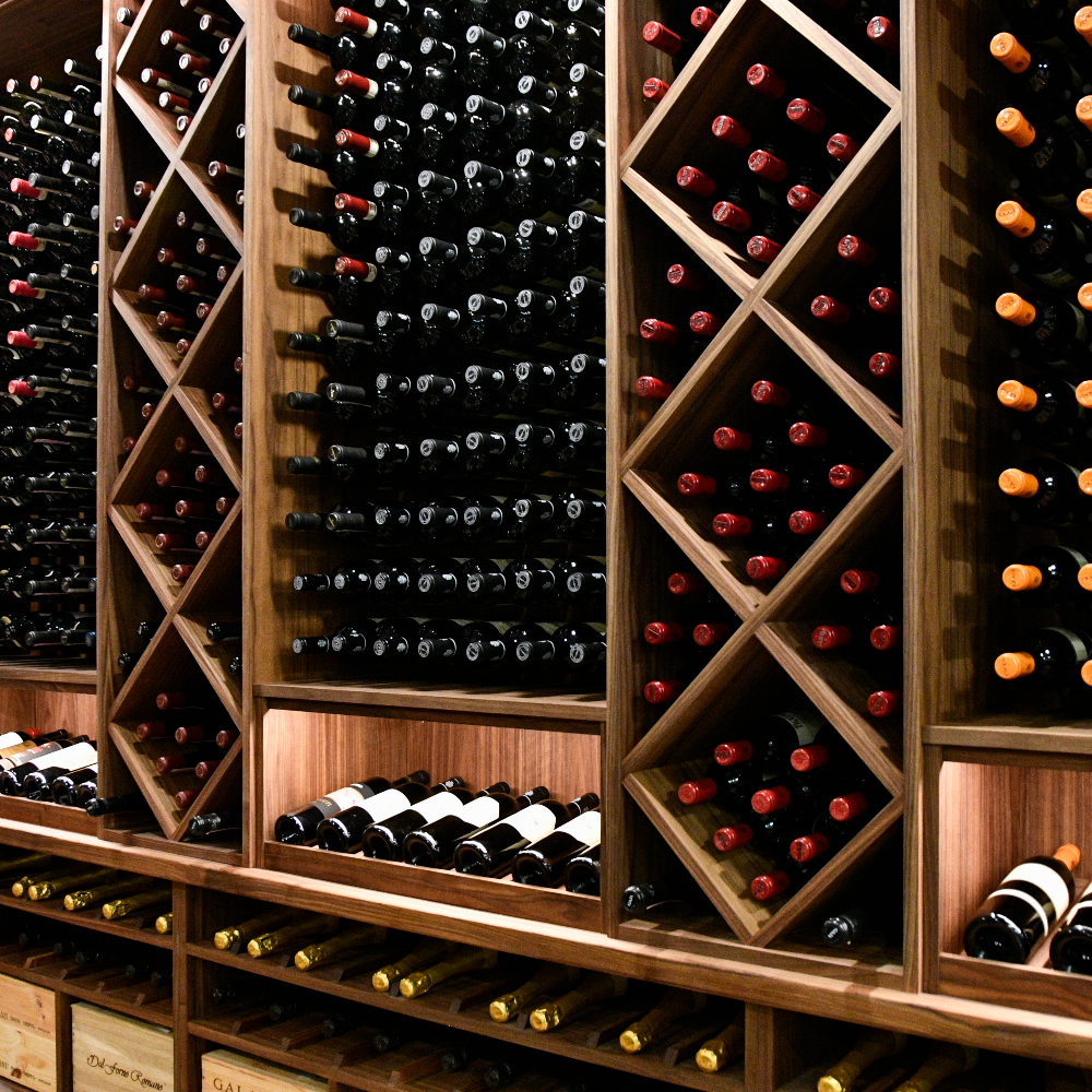 Wooden wine rack with various bottles of wine.