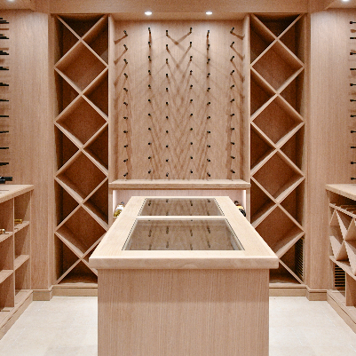 Wooden wine cellar with shelves and a central table.