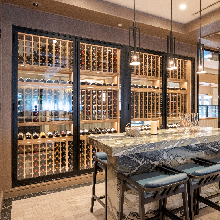 Modern wine cellar with marble bar and stools