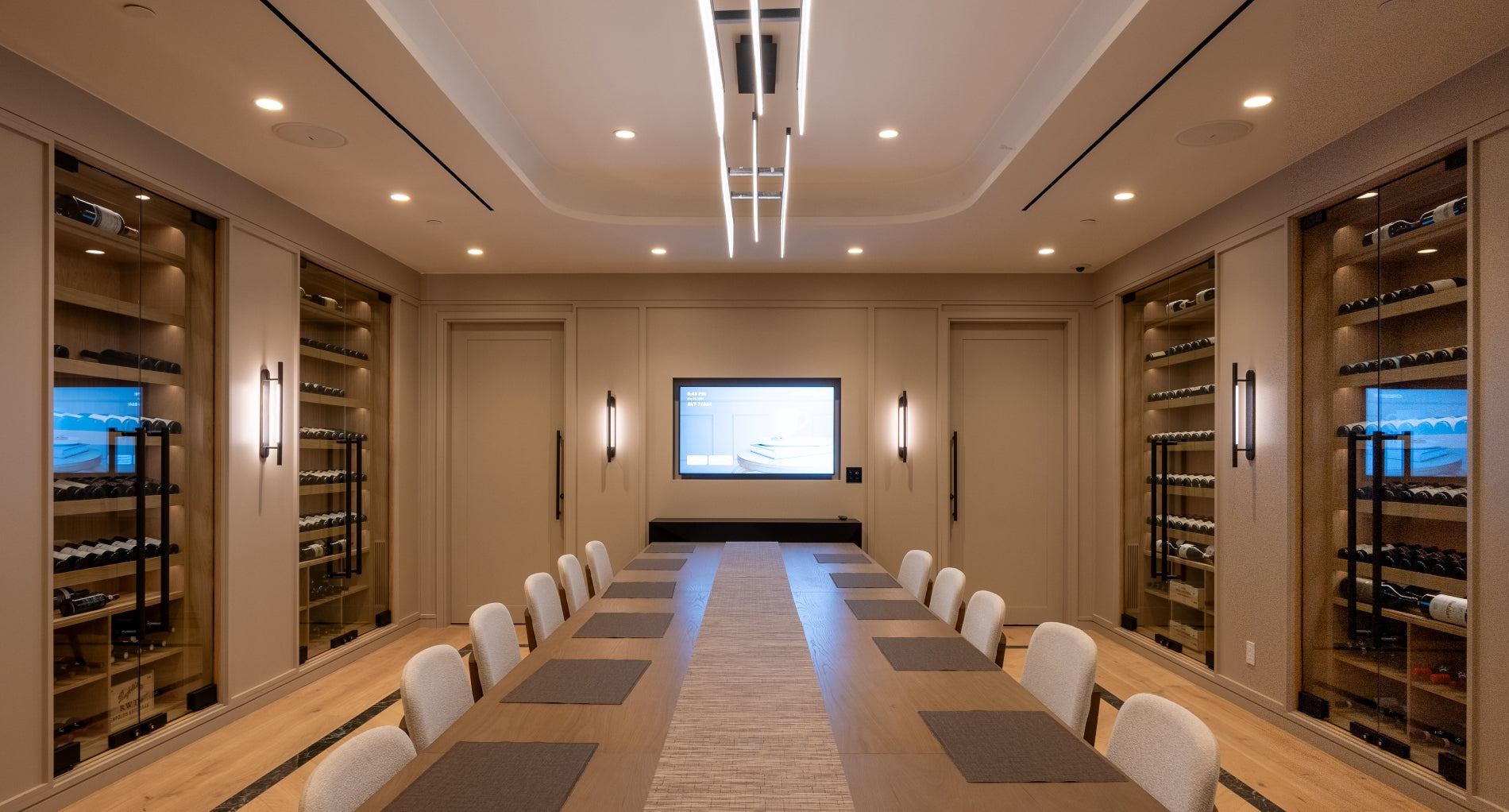 Modern conference room with a large table and wine cellars.
