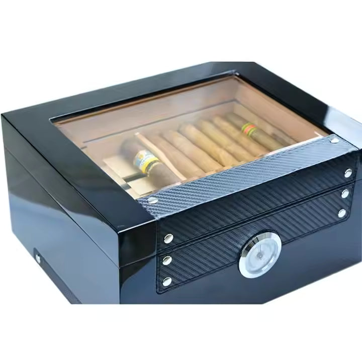 Cigar humidor with glass top and carbon fiber design on a white background