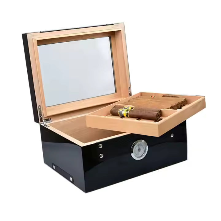 Wooden humidor with glass lid and black base, containing cigars.