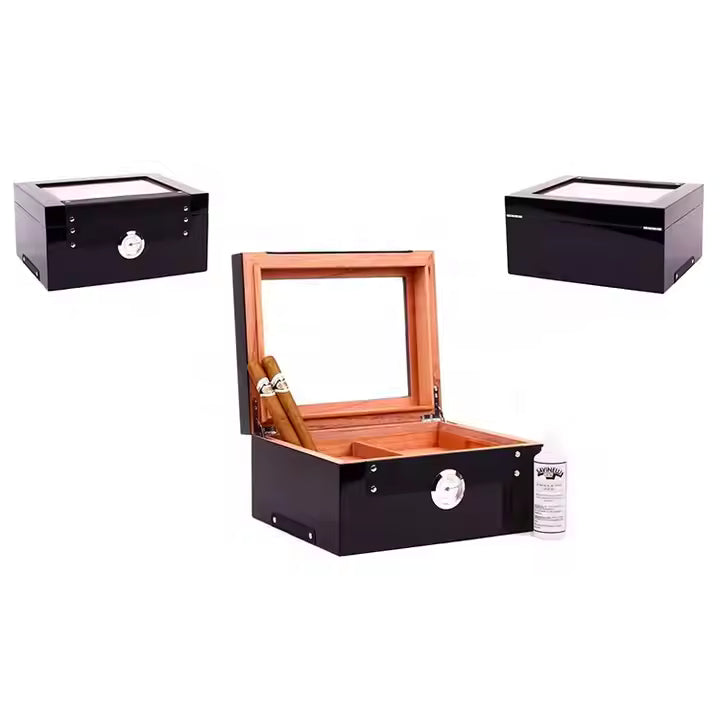 Cigar humidor with two black humidors and a bottle of humidifier solution on a white background