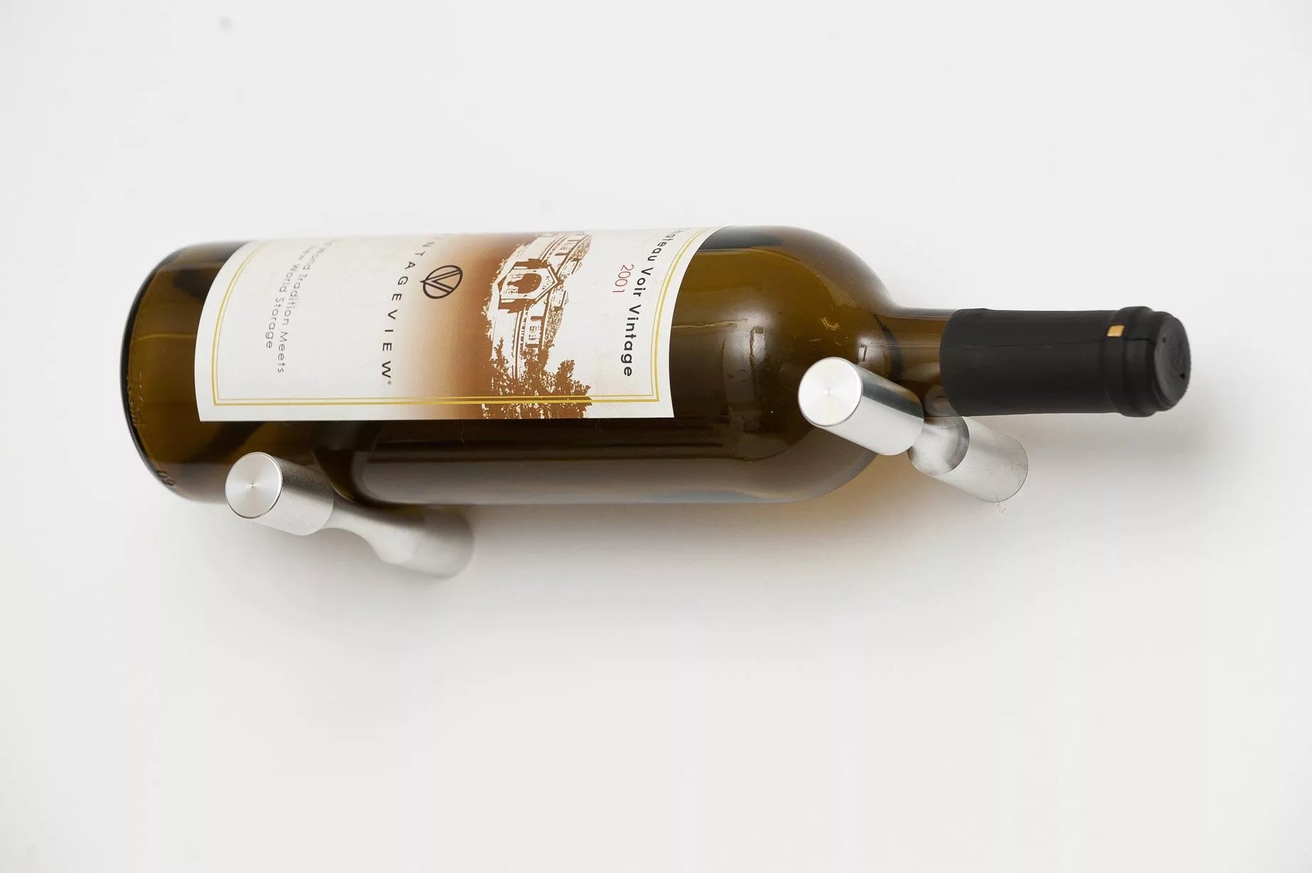 Wine bottle on a white background with a decorative holder.