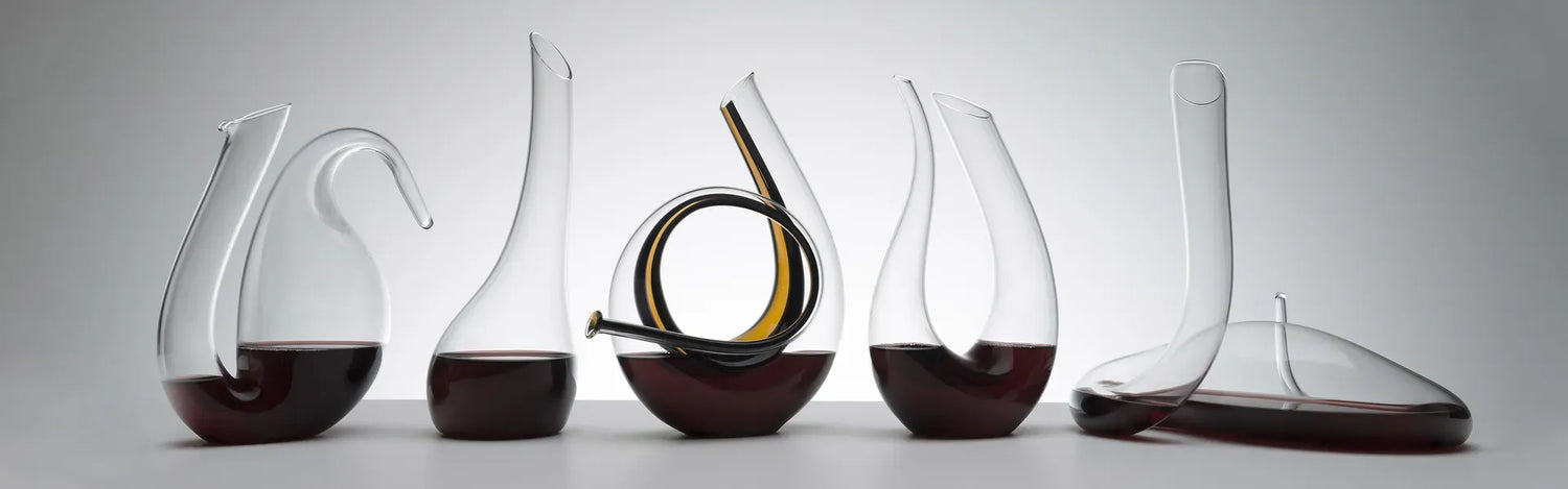 Set of wine decanters with varying designs on a gray background