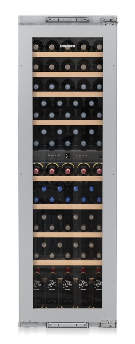 Wine cooler with multiple shelves filled with wine bottles on a white background