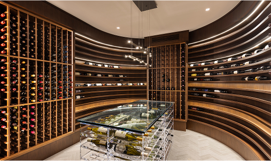 Modern wine cellar with curved wooden shelves and glass display table.