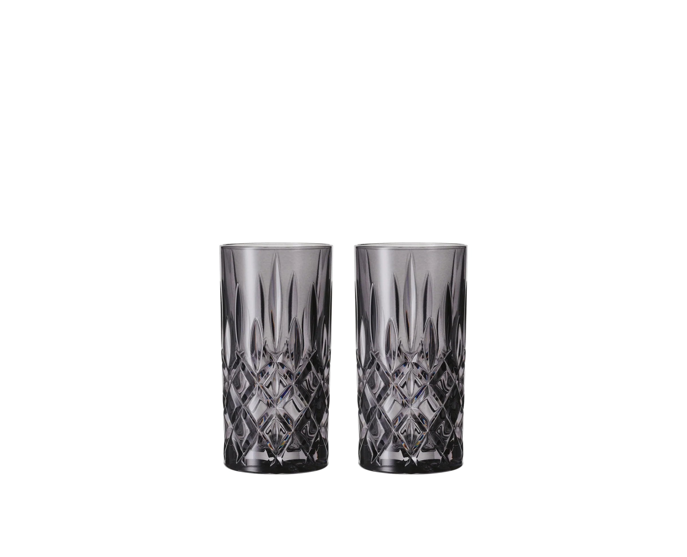 Two crystal glasses with diamond cut pattern on a white background