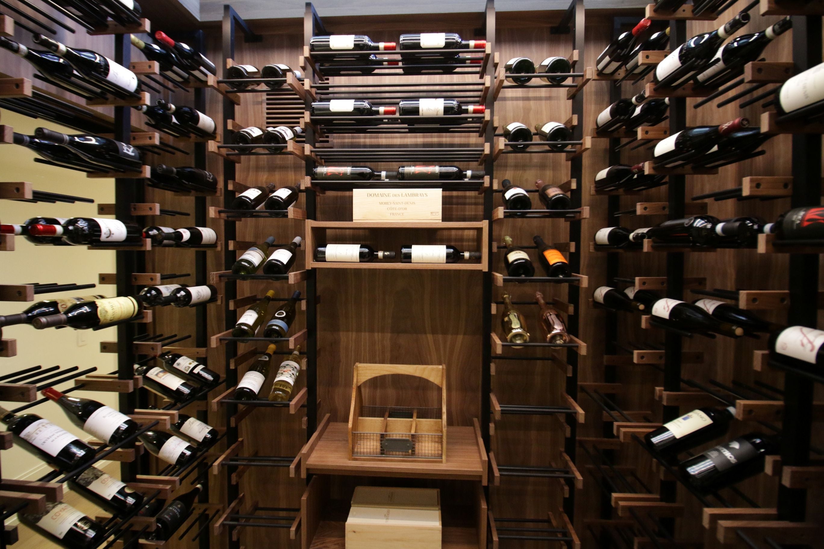Wine bottles arranged on a Premier CRU with shelves filled.