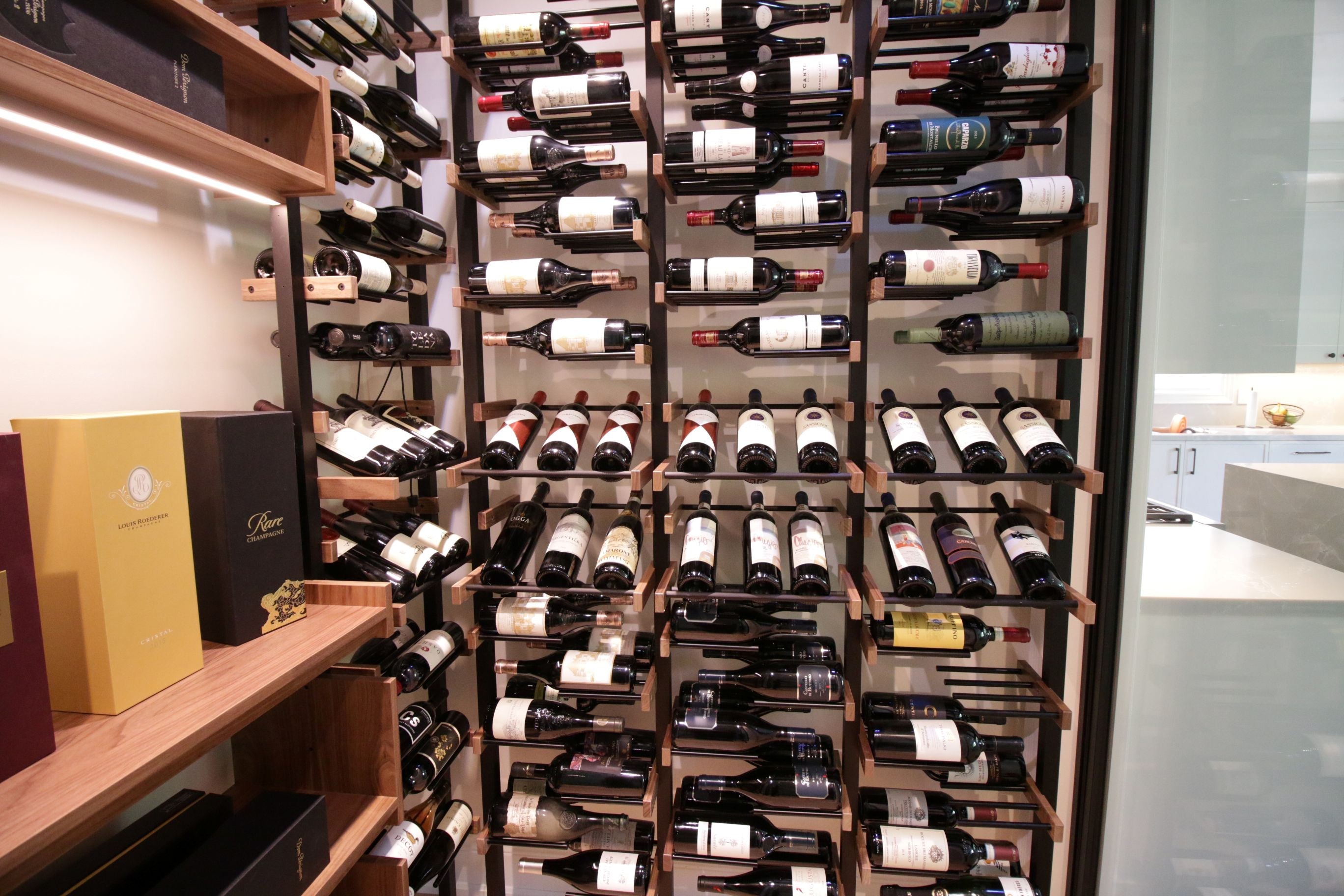 Premier CRU Wine bottles arranged on wooden shelves.