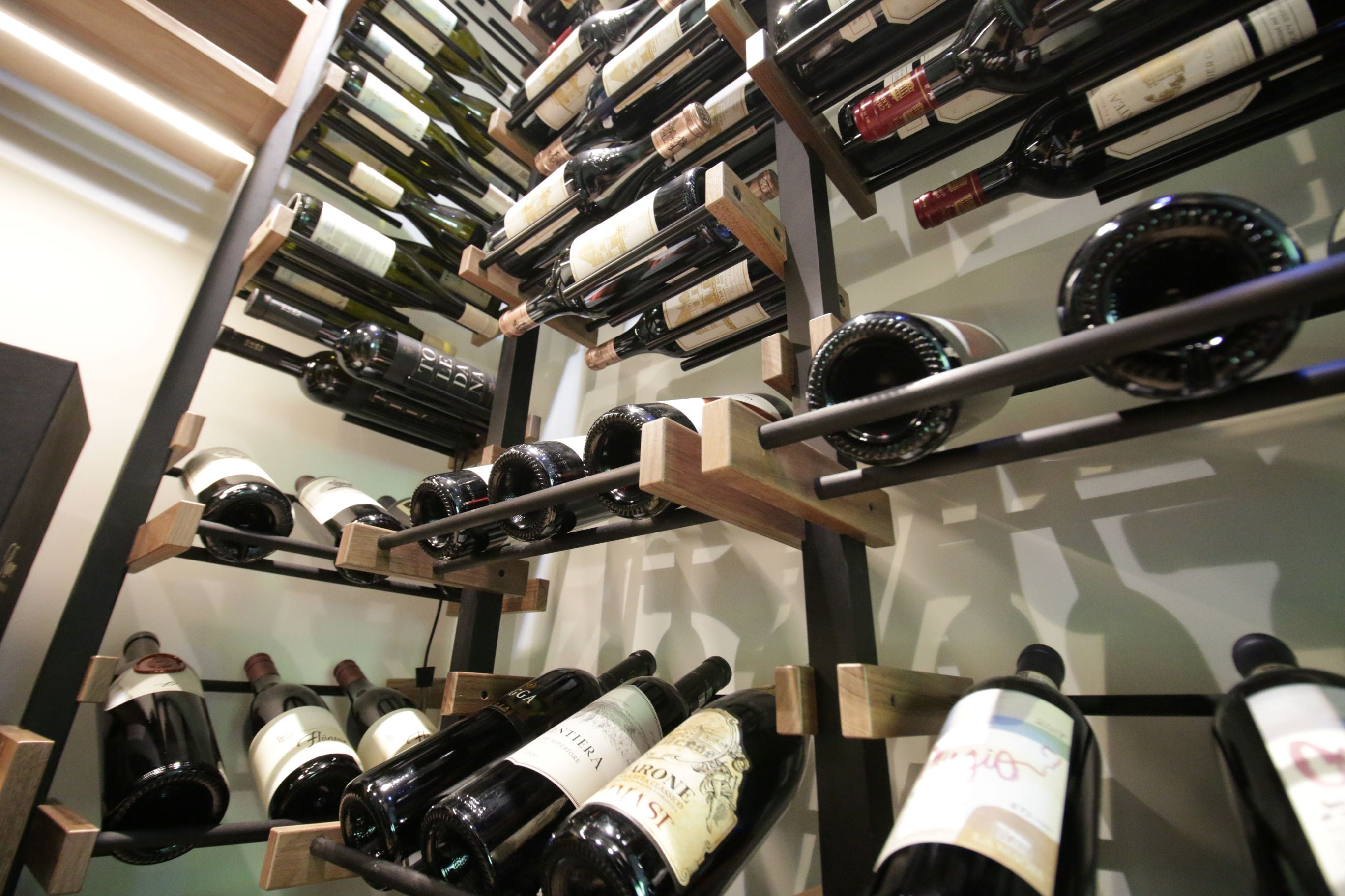 Wine bottles arranged on a Premier CRU shelves in a wine cellar.