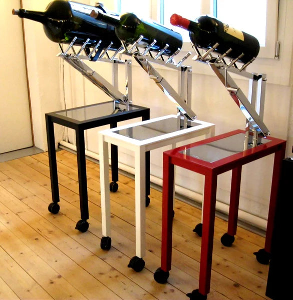Three wine racks with bottles on a wooden floor.