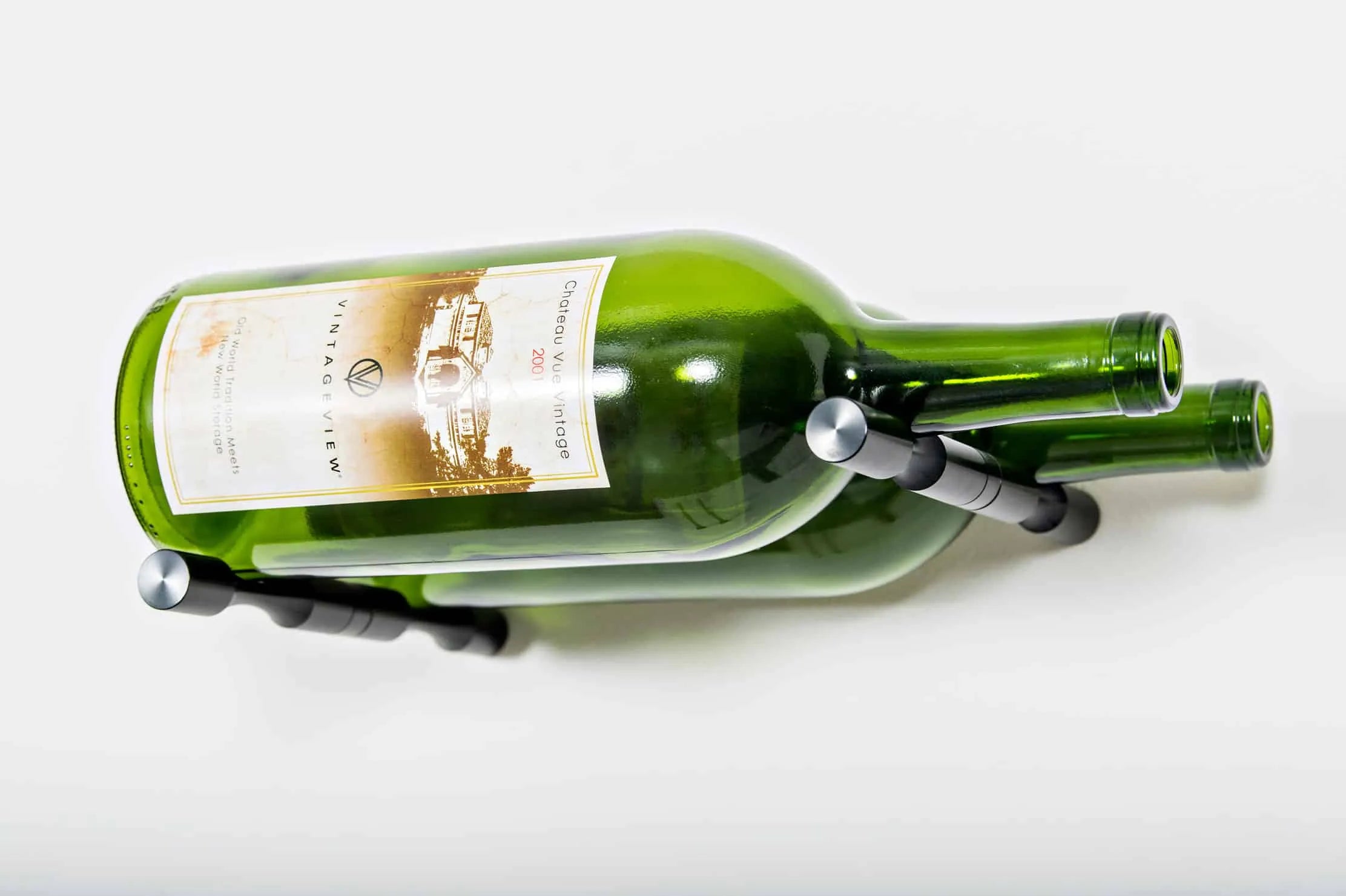 Two green wine bottles with a holder on a white background